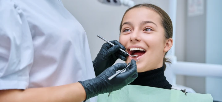 Child receiving a dental check-up with a bright,