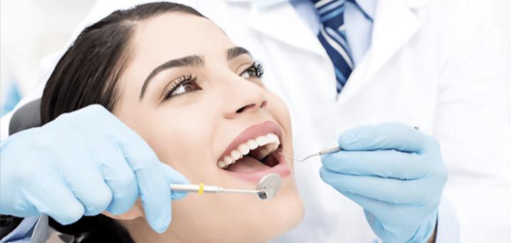 Friendly dentist checking a patient's teeth